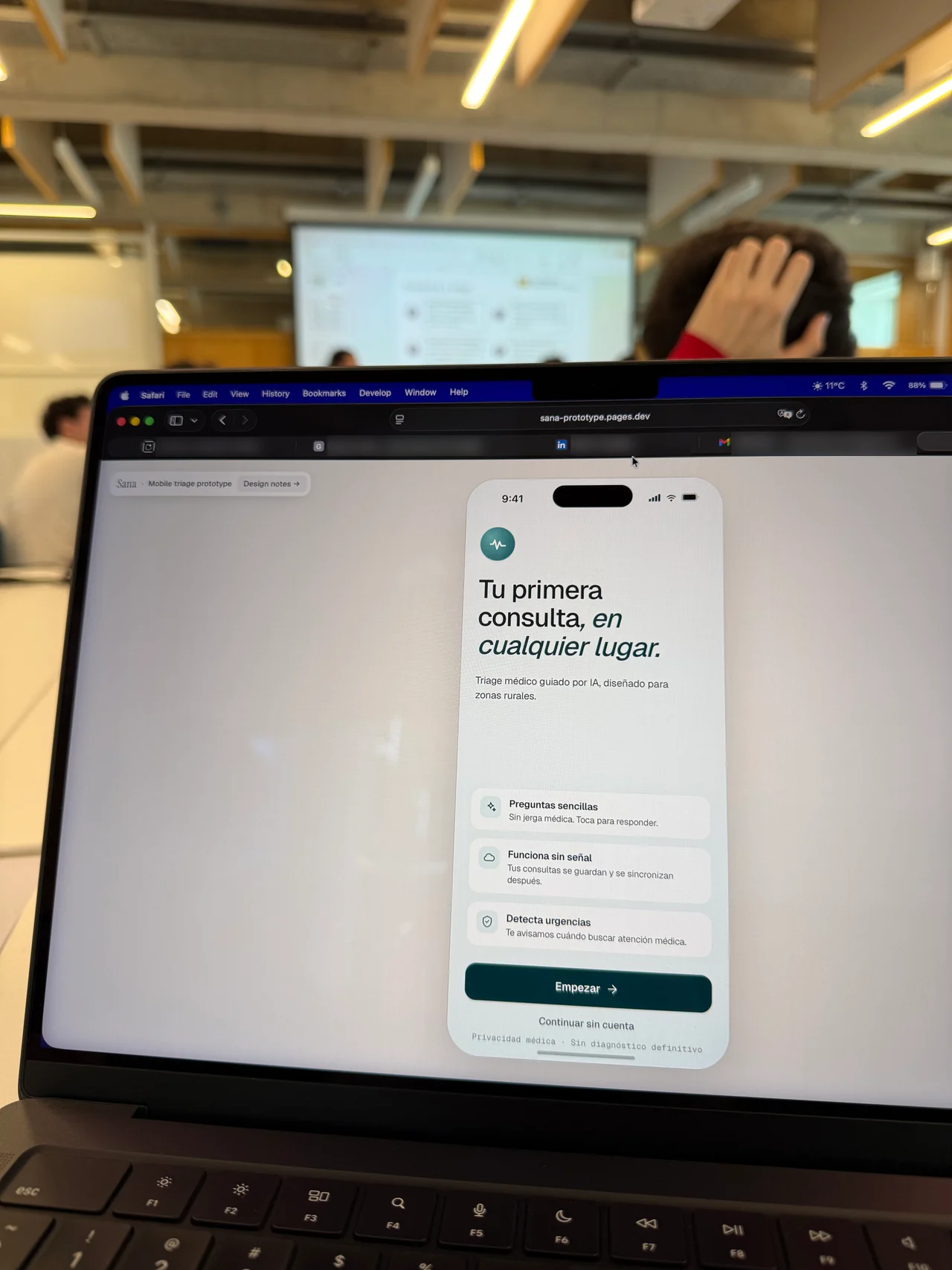 A laptop displaying Sana's mobile triage prototype, including its offline and emergency guidance